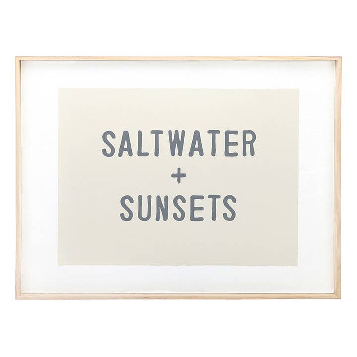 Framed coastal wall art reading "SALTWATER + SUNSETS"