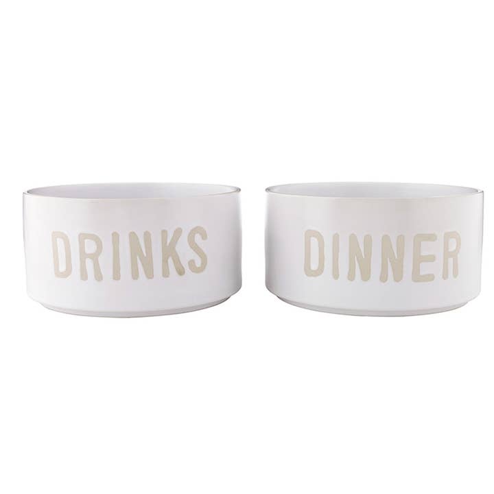 Set of two white stoneware pet bowls embossed with "DRINKS" and "DINNER"
